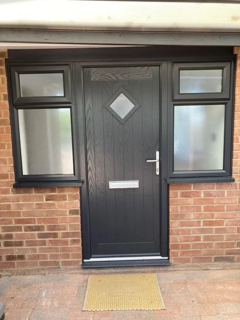 Black composite front door with diamond glass and matching side panels