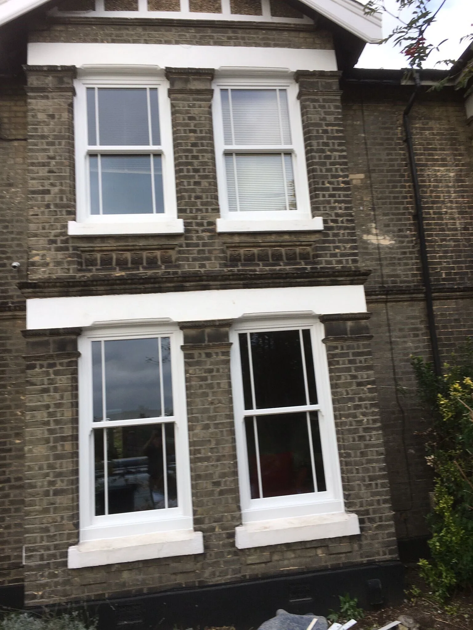 White sliding sash windows on a Victorian brick terrace