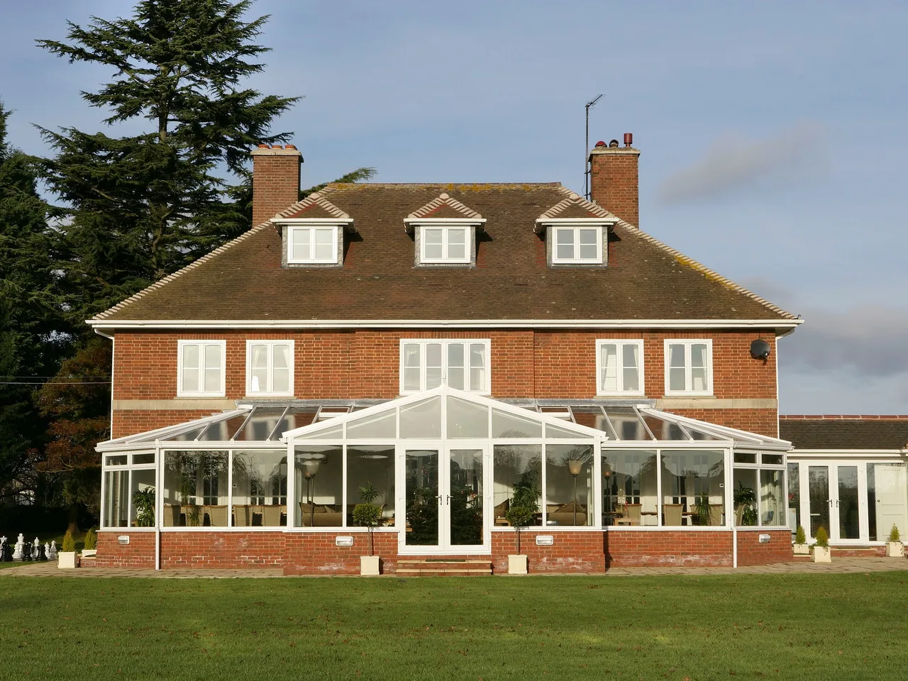 White uPVC Edwardian conservatory on a brick bungalow with a glazed roof