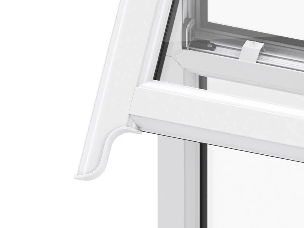 Close-up of a decorative white sash horn on the upper sash of a window, shown with the sash open