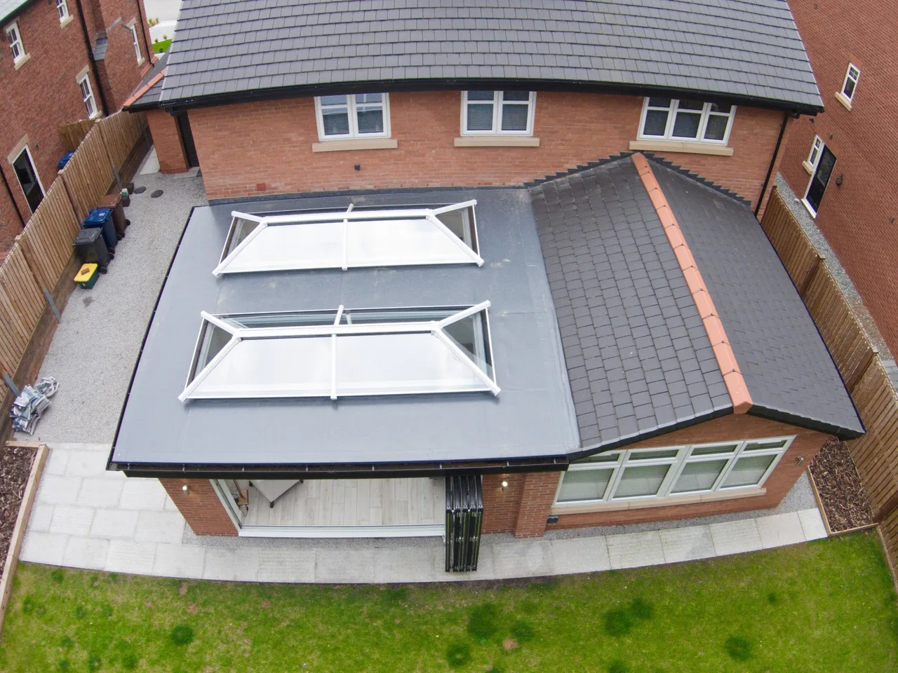 Cream kitchen with a flat rooflight in the ceiling bringing daylight over the worktops