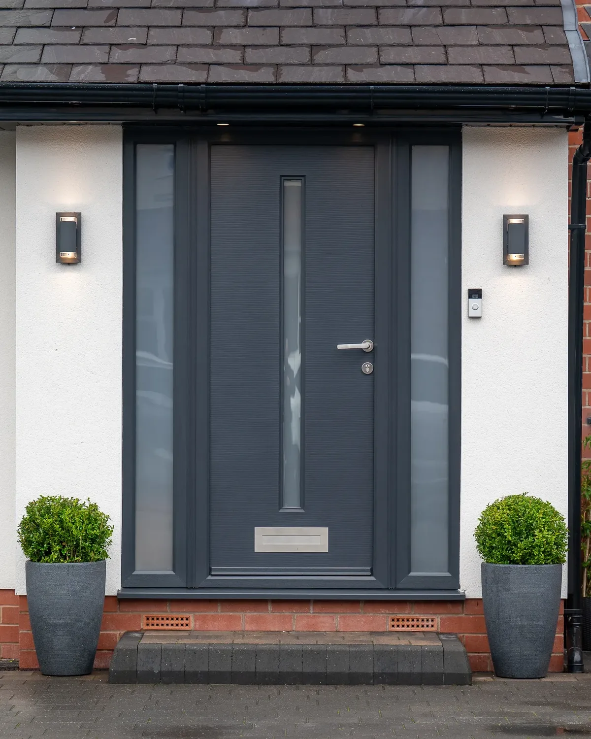 Anthracite grey contemporary front door with frosted sidelights and stainless steel handle