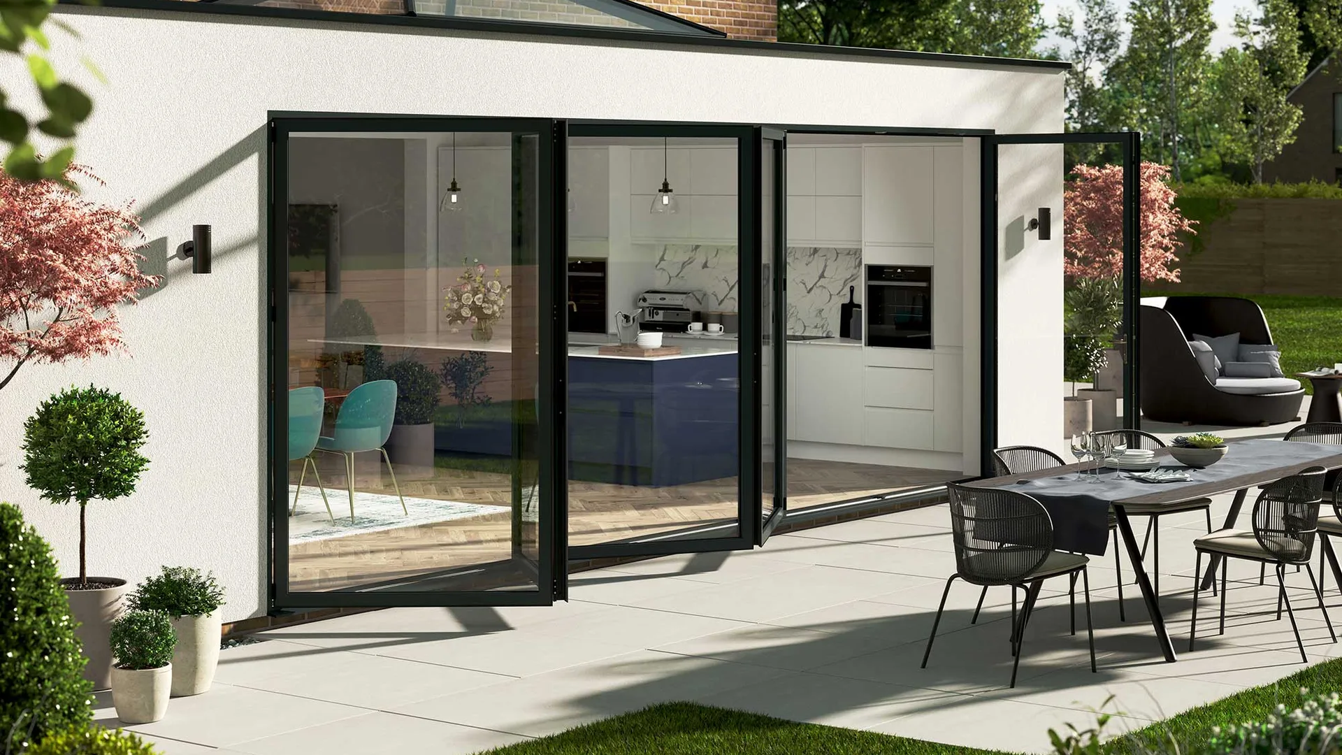 Dark grey aluminium bifold doors part open from a rendered rear extension onto a patio with a dining table