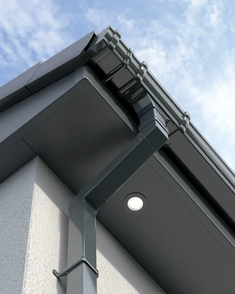 Anthracite grey fascia and soffit with a downlight, square guttering and downpipe at a rendered wall corner