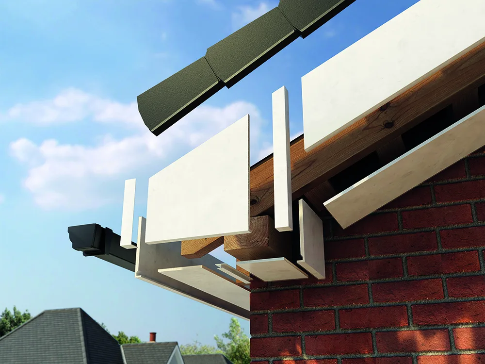 Cutaway view of white fascia and soffit boards fitting to roof timbers above a red brick wall