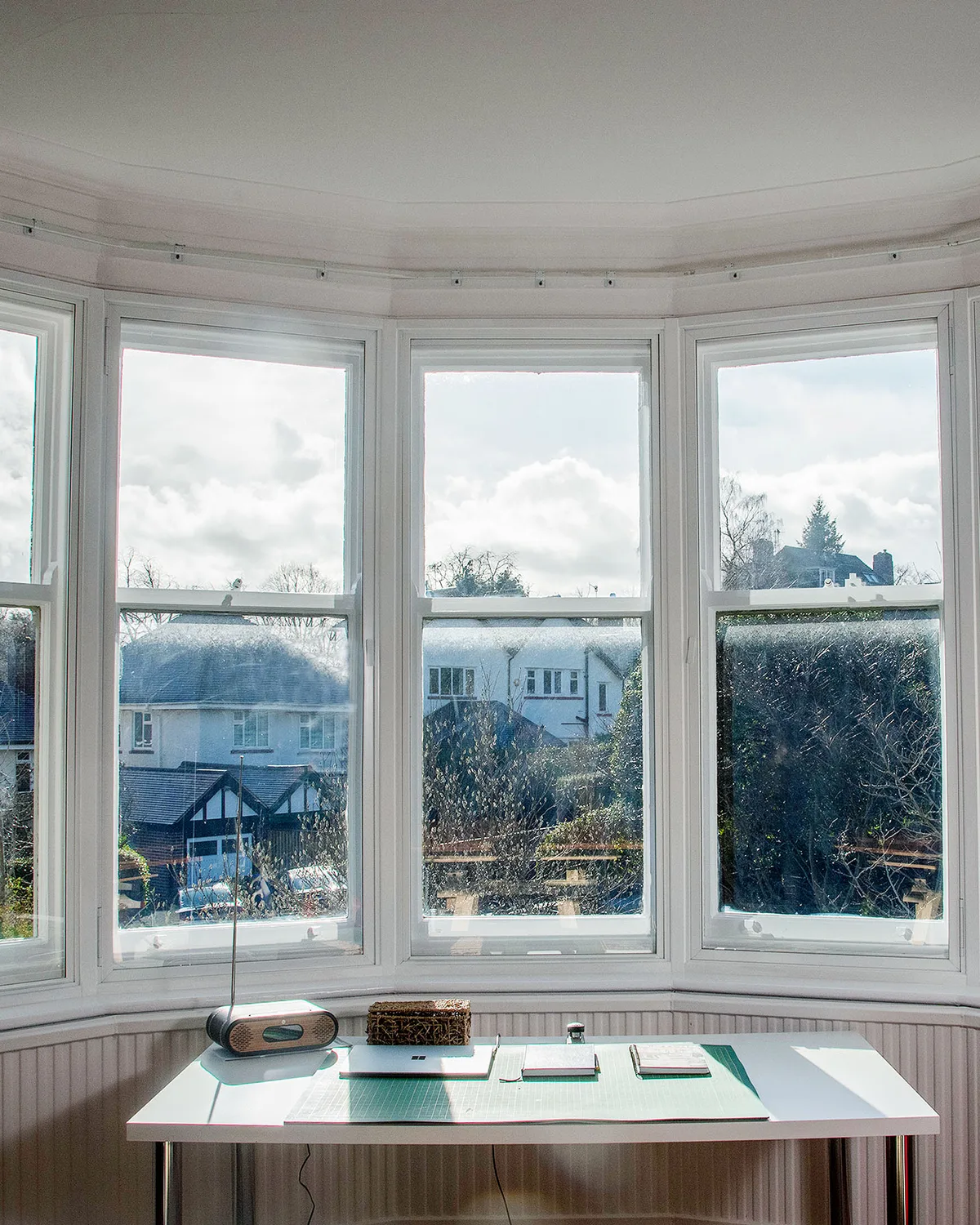 Bay of timber sash windows with slim secondary glazing panels fitted inside